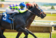 How to Watch the Kentucky Derby 2023 Two jockeys racing horses in preparation for the Kentucky Derby