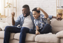 How to Watch the ESPYs 2023 Father and son celebrating on the couch while watching the ESPY Awards