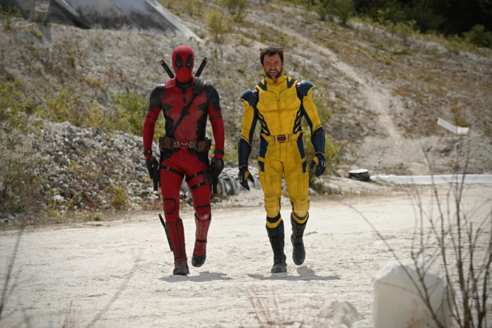 Ryan Reynolds as Deadpool and Hugh Jackman as Wolverine walking in their super suits on the set of Deadpool & Wolverine.