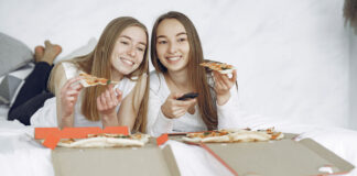 The Best Female-Lead TV Shows To Stream Right Now Two happy women with open pizza boxes enjoying a streaming tv movie.