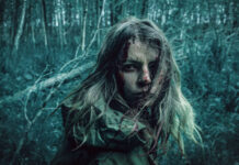 The Best Horror Movies Directed by Women — And Where to Watch Them A dramatic portrait of a distressed woman in a dark, eerie forest setting.
